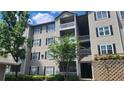 Exterior view of a three-story apartment building with balconies and black shuttered windows at 1250 Parkwood Cir # 2112, Atlanta, GA 30339