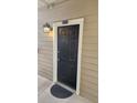 Exterior view of the home's front door with modern lighting and hardware at 1250 Parkwood Cir # 2112, Atlanta, GA 30339