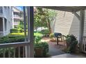 View of a private patio with lush landscaping and grill, perfect for outdoor living at 1250 Parkwood Cir # 2112, Atlanta, GA 30339