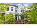 Charming two-story townhome with a brick-accented facade, an inviting staircase, and well-manicured landscaping at 219 Phillips Ln, Alpharetta, GA 30009