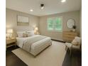 Stylishly staged bedroom with a neutral color palette, natural light, and hardwood floors at 2851 Headland Dr, East Point, GA 30344