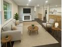 Open-concept living area featuring a fireplace, hardwood floors, and seamless kitchen access at 2851 Headland Dr, East Point, GA 30344