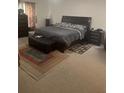 Comfortable bedroom features a queen-sized bed, stylish furniture, and neutral decor for a relaxing retreat at 947 Simonton View Ln, Lawrenceville, GA 30045