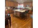 Expansive kitchen with a large island, wooden cabinets, and hardwood floors, perfect for culinary enthusiasts at 947 Simonton View Ln, Lawrenceville, GA 30045