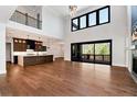 Expansive living room with hardwood floors, soaring ceilings, and a wall of windows at 320 Dodd Ln, Alpharetta, GA 30005