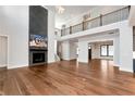 Spacious living room with hardwood floors, high ceilings, and a fireplace with a large TV at 320 Dodd Ln, Alpharetta, GA 30005
