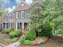 Beautiful two-story brick home with mature trees, lush landscaping, and a welcoming front porch at 5000 Davenport Pl, Roswell, GA 30075