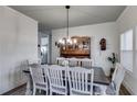 Formal dining room with wood table, seating for six and elegant chandelier at 1721 Mcgarity Rd, Temple, GA 30179
