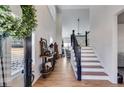 Bright open foyer with wood-look floors and a staircase leading to the second floor at 1721 Mcgarity Rd, Temple, GA 30179