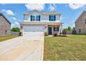Charming two-story home featuring a two-car garage, brick accents, and a well-manicured lawn at 180 Oliver Dr, Locust Grove, GA 30248