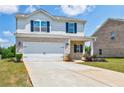Charming two-story home featuring a two-car garage, brick accents, and a well-manicured lawn at 180 Oliver Dr, Locust Grove, GA 30248