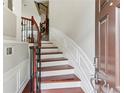 Inviting entryway with hardwood stairs, white wainscoting, and iron railing at 2149 Shoop Se Ct # 3, Smyrna, GA 30080