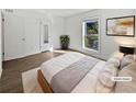 Bright staged bedroom with wood-look floors, a neutral color scheme, and ample natural light at 607 Park Ridge Cir, Marietta, GA 30068