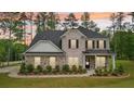 Beautiful two-story home featuring a combination of stone and brick, a dark roof, and a neatly landscaped front yard at 130 W Pier Way, Fayetteville, GA 30214