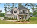 Attractive two-story home with brick and siding, complemented by a well-manicured lawn and mature landscaping at 130 W Pier Way, Fayetteville, GA 30214