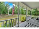 Inviting front porch with a view of the large front yard, perfect for relaxing and enjoying the outdoors at 305 Devilla Trce, Fayetteville, GA 30214