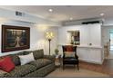 Cozy living room features a comfortable sofa, accent chair, and built-in shelving with pass-through to the kitchen at 3119 Colonial Way # H, Atlanta, GA 30341