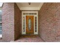 Charming brick home featuring a front door with decorative glass sidelights and transom at 4561 Jenkins Way, Douglasville, GA 30135