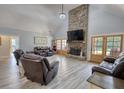 Cozy living room featuring a stone fireplace, wood floors, and comfortable leather seating arrangement at 540 Benton Rd, Covington, GA 30014