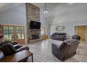 Spacious living room with stone fireplace, wood floors, and french doors leading to outdoor area at 540 Benton Rd, Covington, GA 30014