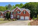 Charming brick home boasts well-maintained landscaping and an attached two-car garage at 1105 Anemone Nw Way, Acworth, GA 30102