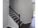 Staircase with dark wood treads and white risers leading to the upper level of the home at 1632 Lenox Overlook Ne Rd, Brookhaven, GA 30329
