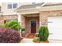 Inviting front entrance with a wreath-adorned door, brick accents, and well-maintained landscaping at 2141 Slick Stone Dr, Snellville, GA 30078