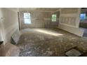 Spacious living room featuring windows and hardwood floors ready for renovation at 4865 Surrey Dr, Roswell, GA 30075