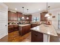 Spacious kitchen features wooden cabinetry, an island with granite countertops, and modern stainless steel appliances at 65 Waters Edge Ln, Covington, GA 30014