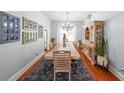 Spacious dining room featuring hardwood floors, a long table, and natural light at 111 Springshade Ln, Canton, GA 30114