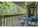 Enjoy a relaxing outdoor retreat on this cozy balcony with wooded views and seating area at 318 Tuxworth Cir, Decatur, GA 30033