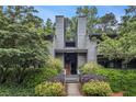 Charming two-story home with lush landscaping, mature trees, and inviting entrance at 318 Tuxworth Cir, Decatur, GA 30033