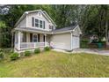 Charming two-story home with a covered front porch and an attached one car garage at 429 Orchard Dr, Stone Mountain, GA 30083
