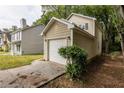 Attached one car garage with a white garage door and a driveway at 429 Orchard Dr, Stone Mountain, GA 30083