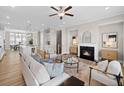 Open-concept living room with a fireplace, stylish furnishings, and seamless flow into the dining area at 964 Catamaran Ct, Alpharetta, GA 30005