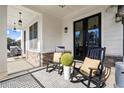 Cozy front porch featuring rocking chairs, stylish decor, and a welcoming atmosphere at 2005 Haley Walk, Woodstock, GA 30188