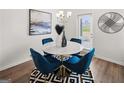 Cozy dining area features a modern round table with blue velvet chairs and sleek decor at 216 Eping Dr, Stockbridge, GA 30281