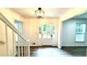 Bright foyer features wood floors, a modern light fixture, and a charming glass paneled entry door at 313 Summit Ridge Dr, Lawrenceville, GA 30046
