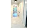 Hallway with white marble floors leads to a well-lit area, creating a clean and open feel at 313 Summit Ridge Dr, Lawrenceville, GA 30046