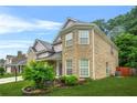 Lovely two-story brick home features a manicured lawn and side yard landscaping at 3492 Newtons Crest Cir, Snellville, GA 30078