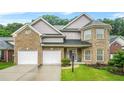 Charming two-story brick home with attached two-car garage and well-manicured lawn at 3492 Newtons Crest Cir, Snellville, GA 30078