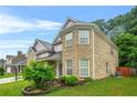 Lovely two-story brick home features a manicured lawn and side yard landscaping at 3492 Newtons Crest Cir, Snellville, GA 30078