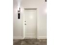 Apartment 304's white door with modern handle and wall sconce at 3655 Peachtree Ne Rd # 304, Atlanta, GA 30319