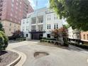 Charming building exterior featuring a circular driveway and attractive landscaping at 3655 Peachtree Ne Rd # 304, Atlanta, GA 30319