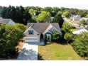 An aerial view of a charming home with a well-kept lawn, nestled in a lush, green neighborhood at 2721 Maeve Ct, Dacula, GA 30019