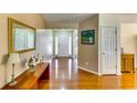 Bright foyer with hardwood floors, a decorative mirror, and a view into the home at 2721 Maeve Ct, Dacula, GA 30019