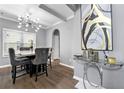 Modern dining room with a stylish chandelier, coffered ceiling, and sophisticated decor at 1892 Ivy View Walk, Loganville, GA 30052