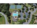 A high angle aerial view of community amenities including pool, tennis courts, and playground, set within lush greenery at 55 Little Barley Ln, Grayson, GA 30017
