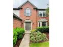 Inviting entryway featuring a brick facade, manicured landscaping, and a welcoming front door at 655 Wellingborough Ct, Alpharetta, GA 30005