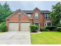 Traditional brick home with a well-kept lawn and a two-car garage at 655 Wellingborough Ct, Alpharetta, GA 30005